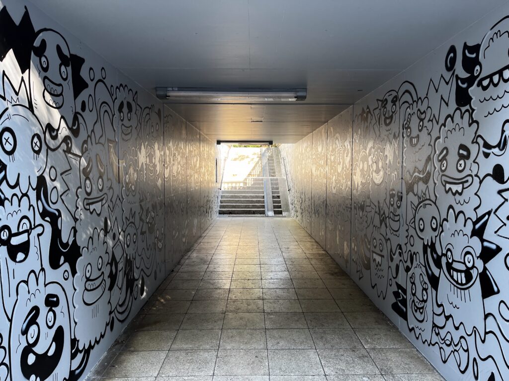Colourful monster figures painted by Fatin Rahmouni along the walls of the Radolfzell pedestrian underpass.